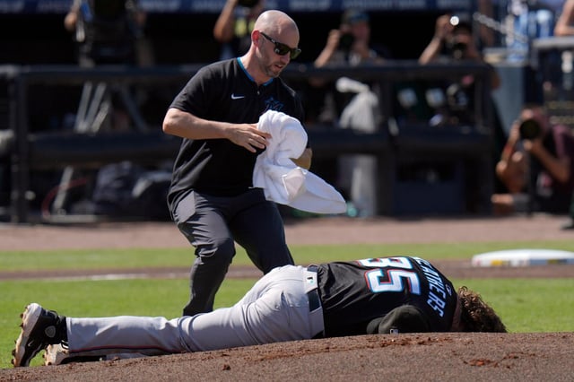 A Miami Marlins trainer rushes out to help pitcher Ryan Weathers after he was hit in the head while teammates were warming up before the first inning on Saturday in Tampa.  (AP Photo/Chris O’Meara)