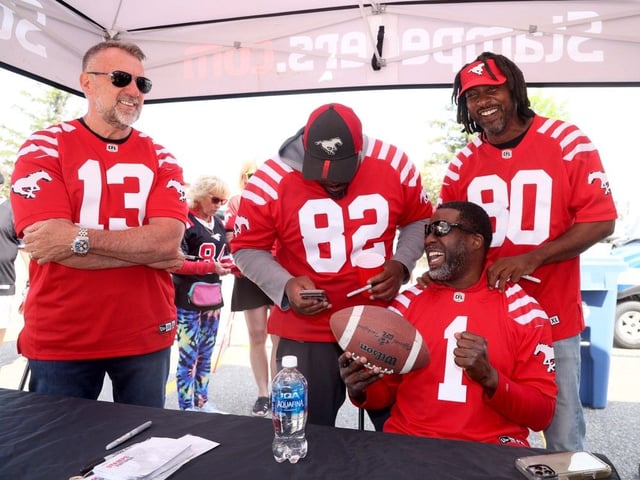  Stampeders alumni Marcus Crandell, Mark McLoughlin, Nik Lewis and Jeremaine Copeland sign autographs on Saturday.