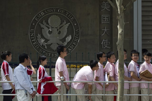 FILE - Chinese students wait outside the U.S. Embassy for their visa application interviews, in Beijing on May 2, 2012. (AP Photo/Alexander F. Yuan, File)