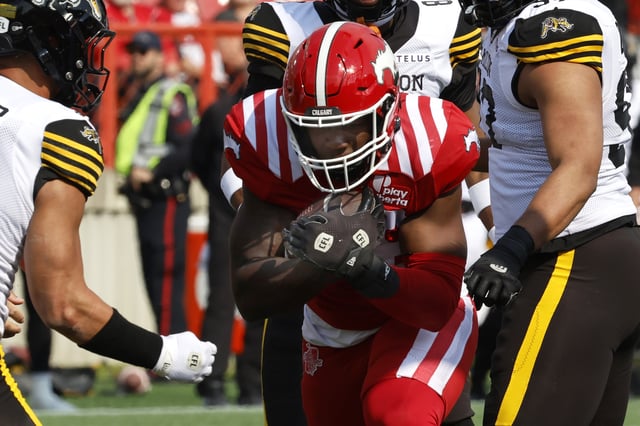Calgary Stampeders' Dedrick Mills runs into the endzone for a touchdown during first half CFL football action against the Hamilton Tiger-Cats in Calgary, on Saturday, June 7, 2025.