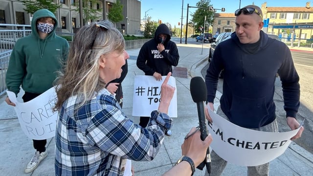 A woman supporting the complainant in the sexual assault trial for five former world junior hockey players confronts a man backing the accused men on May 16, outside the London, Ont., courthouse.