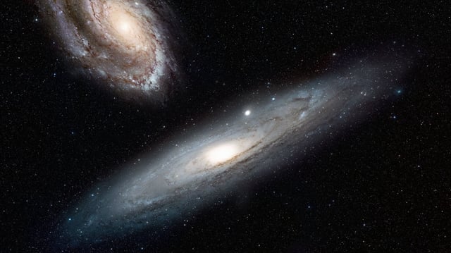 Image showing two galaxies approaching each other.