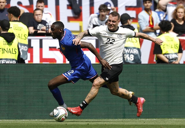Soccer Football - Nations League - Third Place Play Off Match - Germany v France - MHPArena, Stuttgart, Germany - June 8, 2025 France's Randal Kolo Muani in action with Germany's David Raum REUTERS/Heiko Becker