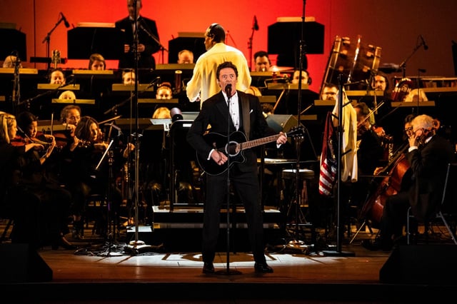 Actor-singer Hugh Jackman kicks off opening night at the Hollywood Bowl on Saturday, June 7, 2025 with conductor Thomas Wilkins and the Hollywood Bowl Orchestra accompanying him. (Photo by Timothy Norris)