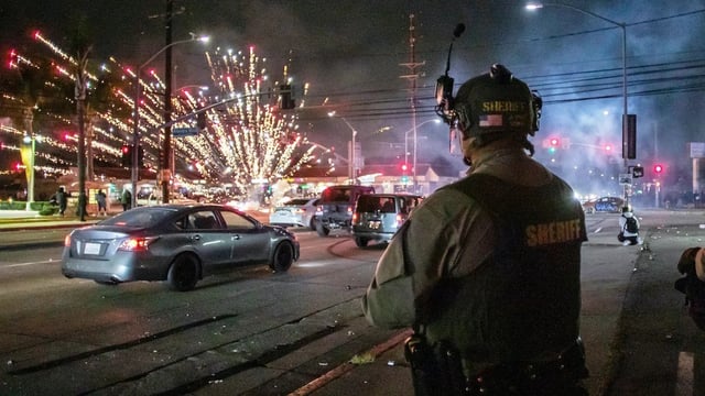 LOS ANGELES, CALIFORNIA - JUNE 7: A firework sent by protesters explodes near by the Los Angeles Sheriff Department officers during immigration protest on June 7, 2025 in Paramount, California. Clashes between the U.S. Border Patrol and protestors began after a Home Depot was raided by Immigration and Customs Enforcement (ICE). Around 30 agents wearing tactical gear were stationed near a Home Depot in Paramount and faced off against protesters, south of downtown Los Angeles.(Photo by Apu Gomes/Getty Images)