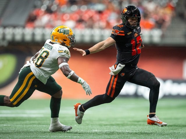  Elusive B.C. Lions quarterback Nathan Rourke escapes the pursuit of Edmonton Elks’ Nick Anderson during 31-14 win Saturday at B.C. Place.