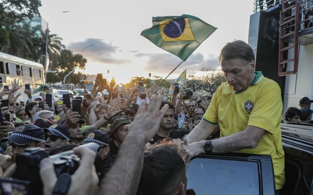 Brazil's former President Jair Bolsonaro greets supporters during a march in Brasilia on May 7, 2025, to demand amnesty for people convicted over a failed insurrection on January 8, 2023
