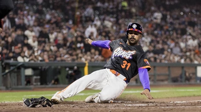 May 13, 2025; San Francisco, California, USA;  San Francisco Giants first baseman LaMonte Wade Jr. (31) slides home to score on a wild pitch by Arizona Diamondbacks relief pitcher Juan Morillo (67) (not pictured) during the fifth inning at Oracle Park. Mandatory Credit: John Hefti-Imagn Images