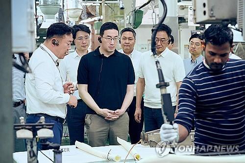 This file photo provided by LG Group shows Chairman Koo Kwang-mo (3rd from L) examining a production line at LG Electronics Inc.'s Noida manufacturing plant in New Delhi in February 2025. (PHOTO NOT FOR SALE) (Yonhap)