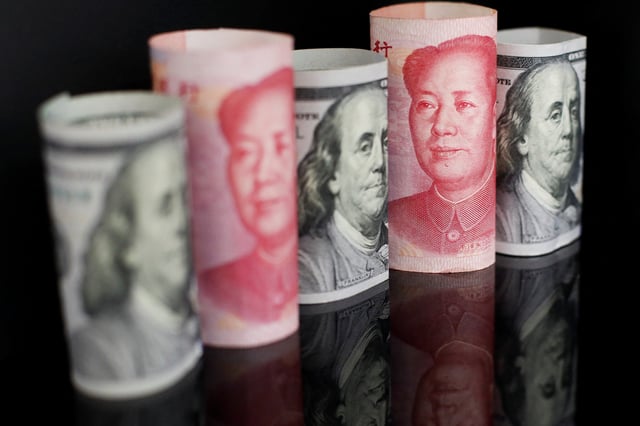 Banknotes of Chinese yuan and U.S. dollar are seen in this illustration picture taken September 29, 2022. REUTERS/Florence Lo/Illustration/File Photo
