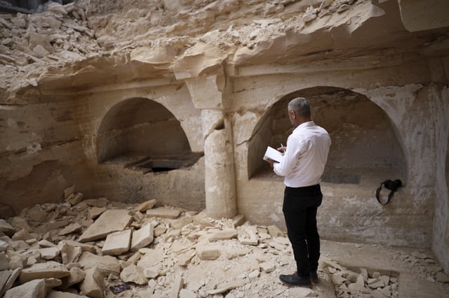 Hassan Ismail of the Idlib Museum takes notes at a Byzantine underground tomb complex, believed to be over 1,500 years old, uncovered by a contractor during reconstruction of a war-damaged house in Maarat al-Numan, Idlib suburb, Syria, on Friday, May 30, 2025. (AP Photo/Omar Albam)