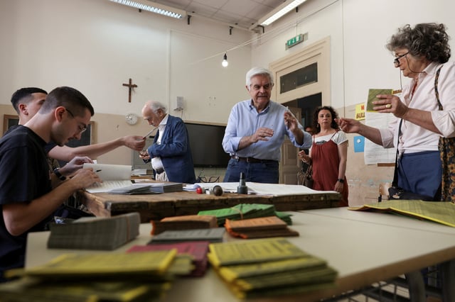People prepare to vote during a referendum on employment and Italian citizenship at a polling station in Rome, Italy, June 8, 2025. REUTERS/Matteo Minnella