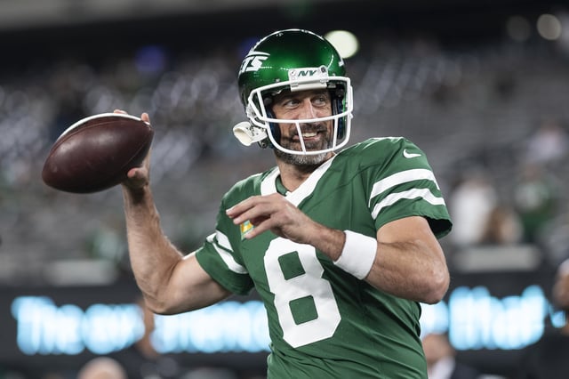Aaron Rodgers #8 of the New York Jets reacts as he throws a pass as he warms up prior to an NFL football game between the New York Jets and the New England Patriots at MetLife Stadium on September 19, 2024 in East Rutherford, New Jersey.