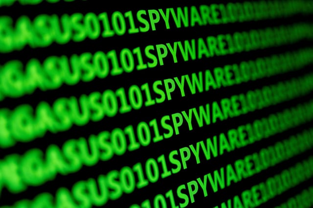 The word spyware and binary code are displayed in this illustration taken May 4, 2022. REUTERS/Dado Ruvic/Illustration/ File Photo