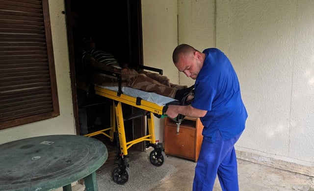 A medic transports an elderly person on a stretcher outside an illegal hospice in the village of Yagoda, Bulgaria, in this image released to Reuters on June 9, 2025. Bulgarian Ministry of Justice/Handout via REUTERS ATTENTION EDITORS - THIS IMAGE HAS BEEN SUPPLIED BY A THIRD PARTY. NO RESALES. NO ARCHIVES. BEST QUALITY AVAILABLE.