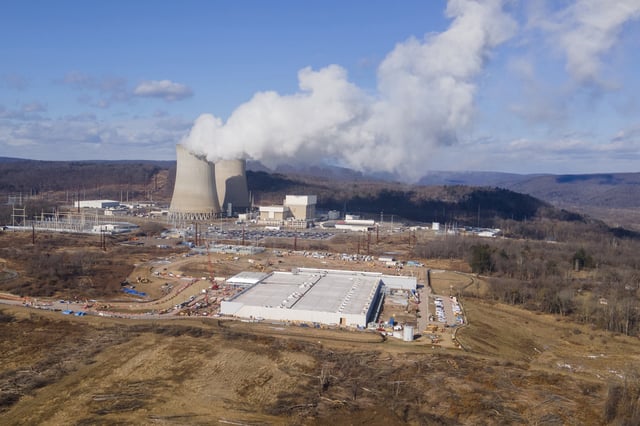 FILE - A data center owned by Amazon Web Services, front right, is under construction next to the Susquehanna nuclear power plant in Berwick, Pa., on Tuesday, Jan. 14, 2024. (AP Photo/Ted Shaffrey, file)