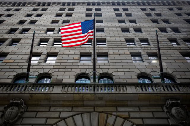 The U.S. flag flies outside The Federal Reserve Bank of New York in New York City, U.S., October 12, 2021.  REUTERS/Brendan McDermid/ File Photo