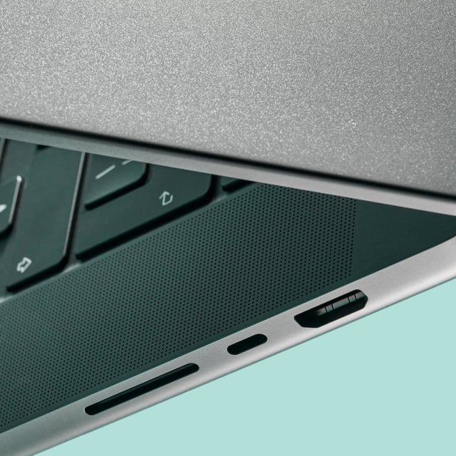 a macbook with a blue-green background
