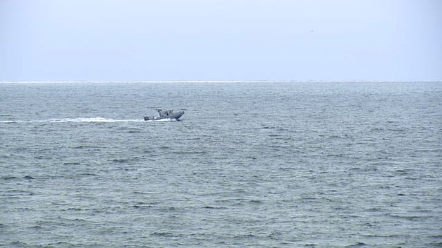 A boat searches for survivors of a plane crash near Point Loma, San Diego, on Monday.
