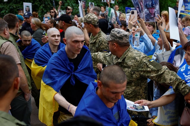 Ukrainian prisoners of war leave a bus as they return after a swap, amid Russia's attack on Ukraine, in an undisclosed location in Ukraine, June 9, 2025.
