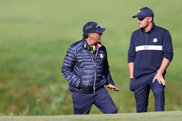 KOHLER, WISCONSIN - SEPTEMBER 25: Vice-captain Phil Mickelson of team United States (L) meets with Bryson DeChambeau of team United States during Saturday Afternoon Fourball Matches of the 43rd Ryder Cup at Whistling Straits on September 25, 2021 in Kohler, Wisconsin.