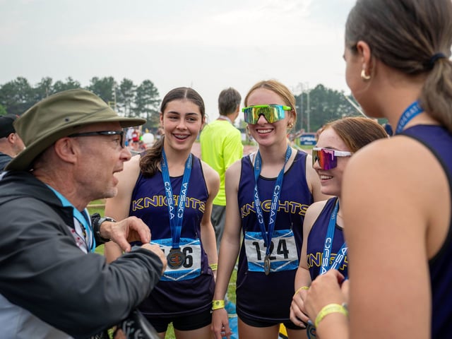  Lo-Ellen Park head coach Colin Ward, left, speaks with his athletes at OFSAA.