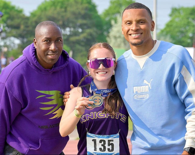Lo-Ellen sprinter Annabelle Richardson poses for a photo with two Olympic gold medallists: local coach Robert Esmie, left, and Andre De Grasse at the 2025 OFSAA track and field championships. Richardson won three medals at the event, including gold in the novice girls 100-metre dash.
