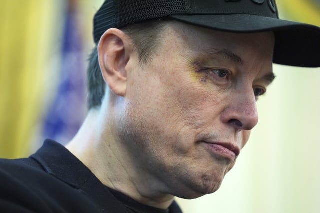 Elon Musk listens as President Donald Trump speaks during a news conference in the Oval Office of the White House, Friday, May 30, 2025, in Washington.
