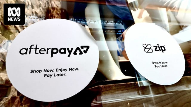 Stickers advertising Afterpay and Zip on the window of a clothing store.
