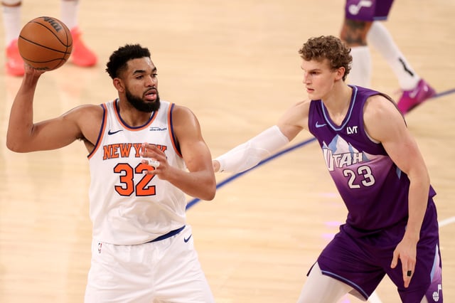Karl-Anthony Towns #32 of the New York Knicks handles the ball defended by Lauri Markkanen #23 of the Utah Jazz during the second half at Madison Square Garden on January 01, 2025 in New York City.