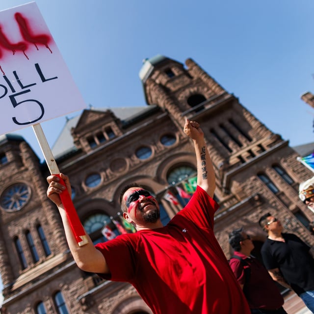 Protesters and community members chant and wave signs, as they listen to speakers during a demonstration opposing Bill 5, outside the Ontario Legislature at Queen's Park in Toronto, Monday, June 2, 2025. THE CANADIAN PRESS/Cole Burston
