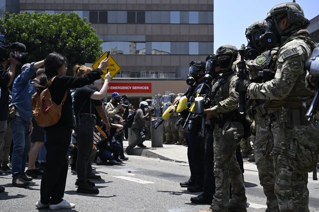 LOS ANGELES, CALIFORNIA - JUNE 8: ICE officers and national guards confront with protesters outside of the Metropolitan Detention Center in Los Angeles, California on June 8, 2025 amid protests over immigration raids. (Photo by Tayfun Coskun/Anadolu via Getty Images)