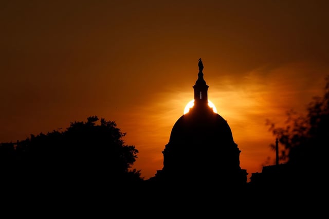 WASHINGTON, DC - JUNE 3: The sun sets behind the U.S. Capitol Building on a warm spring evening on June 3, 2025 in Washington, DC. Smoke from recent wildfires in Canada has drifted into the Washington metropolitan area causing a haze in the sky.