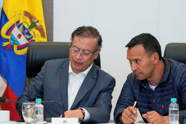 This handout picture released by the Colombian Presidency press office shows President Gustavo Petro (L) talking with Defense Minister Pedro Sanchez during a Security Council meeting after Senator Miguel Uribe was shot and wounded in a campaign event