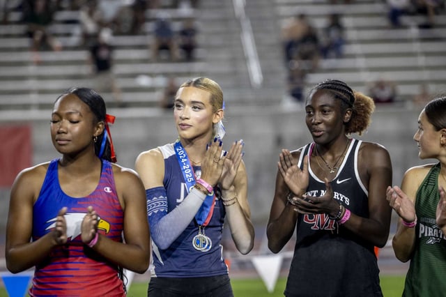 AB Hernandez of Jurupa Valley High School, second left, claps during the triple jump award ceremony at the state meet on May 31.