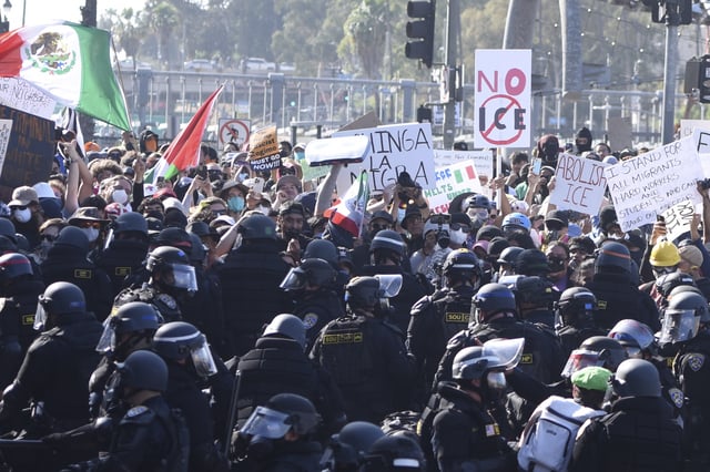 Protesters confront police following recent raids by Immigration and Customs Enforcement (ICE) and Department of Homeland Security (DHS) agents on June 8, 2025 in Los Angeles, California.