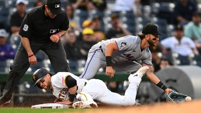 Brett Sullivan (59) of the Pittsburgh Pirates slides safely into third base in front of Connor Norby (1) of the Miami Marlins during the third inning at PNC Park on Monday, June 9, 2025, in Pittsburgh. (Joe Sargent/Getty Images/TNS)