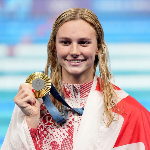 Canada's Summer McIntosh, of Toronto, celebrates with her gold medal won in the 200m women's individual medley final during the 2024 Summer Olympic Games, in Nanterre, France, Saturday, Aug. 3, 2024. THE CANADIAN PRESS/Christinne Muschi