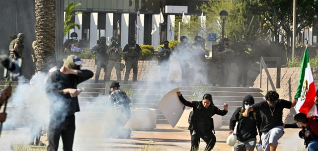 Protester run from police as they use tear gas and flash-bangs at the Federal Building in Santa Ana, CA, on Monday, June 9, 2025. About 400 anti-ICE protesters spent the afternoon carrying signs as they chanted and yelled at police. (Photo by Jeff Gritchen, Orange County Register/SCNG)