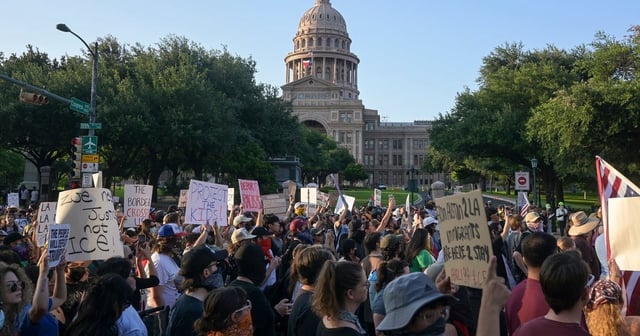 Demonstrators march in front of the Capitol in Austin during a protest against ICE on Monday, June 9, 2025.