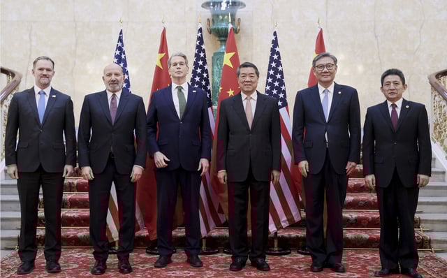 In this photo released by Xinhua News Agency, Chinese Vice Premier He Lifeng, center right, and U.S. Treasury Secretary Scott Bessent, center left, pose for a group photo with delegations before their meeting to discuss China-U.S. trade, in London, Monday, June 9, 2025.