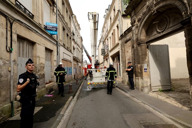 Les pompiers utilisent une grue alors qu'ils recherchent deux collègues portés disparus après avoir été ensevelis sous les décombres en éteignant un incendie dans un immeuble du centre-ville de Laon, au nord de la France, qui n'a pu être maîtrisé que tard dans la nuit, le 10 juin 2025