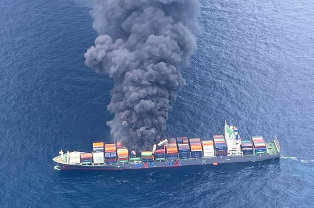 In this photo released by Indian Coast Guard, smoke rises following an explosion and fire onboard a Singapore-flagged container ship off the coast of Kerala, India, Monday, June 9, 2025. (Indian Coast Guard via AP)