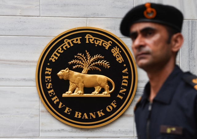 A man walks past the Reserve Bank of India (RBI) logo outside its headquarters in Mumbai, India, June 6, 2025. REUTERS/Francis Mascarenhas/File Photo