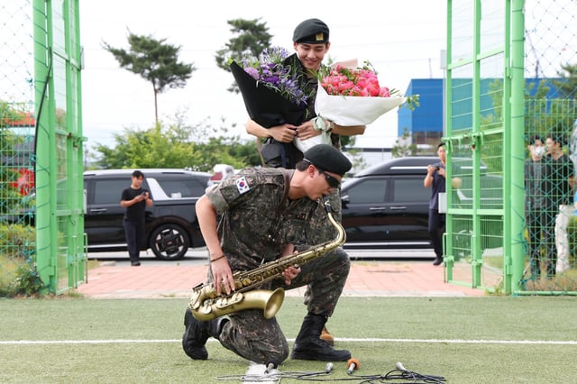 K-pop band BTS's members RM (L) and V (R) react after being discharged from a mandatory military service on June 10, 2025 in Chuncheon, South Korea.