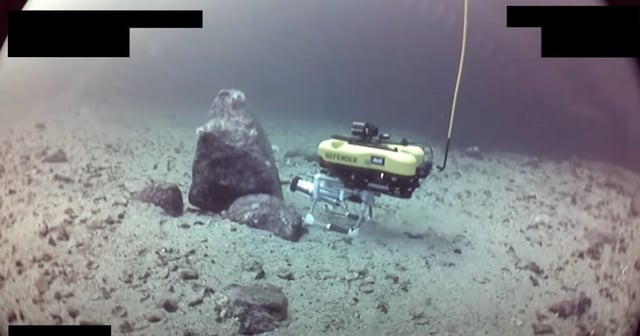 Robot laying an explosive charge on a pipeline "threat"