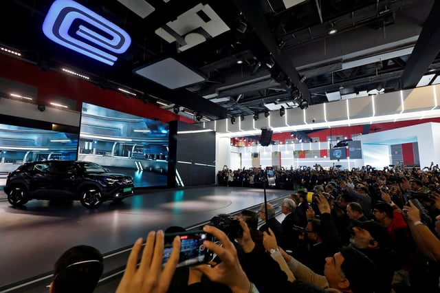 Visitors and media cameramen film Maruti Suzuki's first EV, the e Vitara SUV on display at India's five-day auto show in New Delhi, India, January 17, 2025. REUTERS/Priyanshu Singh/File Photo
