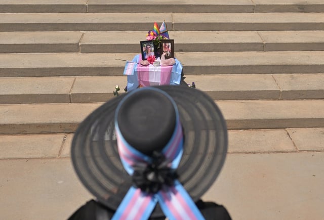 Moxie Far ThunderCrow, a member of Denver’s transgender community, pays respects to 34-year-old hairstylist Jax Gratton, whose body was recently found in an alley in Lakewood. People gathered around a small memorial on the front steps of the Denver City and County Building to hear statements from Gratton’s family on June 9, 2025. (Photo by RJ Sangosti/The Denver Post)