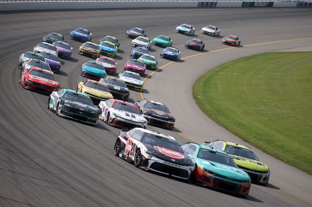 Christopher Bell, driver of the #20 Rheem Toyota, and Michael McDowell, driver of the #71 Delaware Life Chevrolet, race during the NASCAR Cup Series FireKeepers Casino 400 at Michigan International Speedway on June 08, 2025 in Brooklyn, Michigan.
