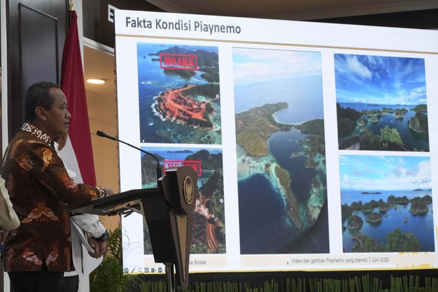 Indonesian Energy and Mineral Resources Minister Bahlil Lahadalia, left, speaks to the media as photos from Raja Ampat Islands, including some AI-generated images that have been circulating on social media, are displayed on a screen in the background, during a press conference at the presidential palace in Jakarta, Indonesia, Tuesday, June 10, 2025. (AP Photo/Achmad Ibrahim)